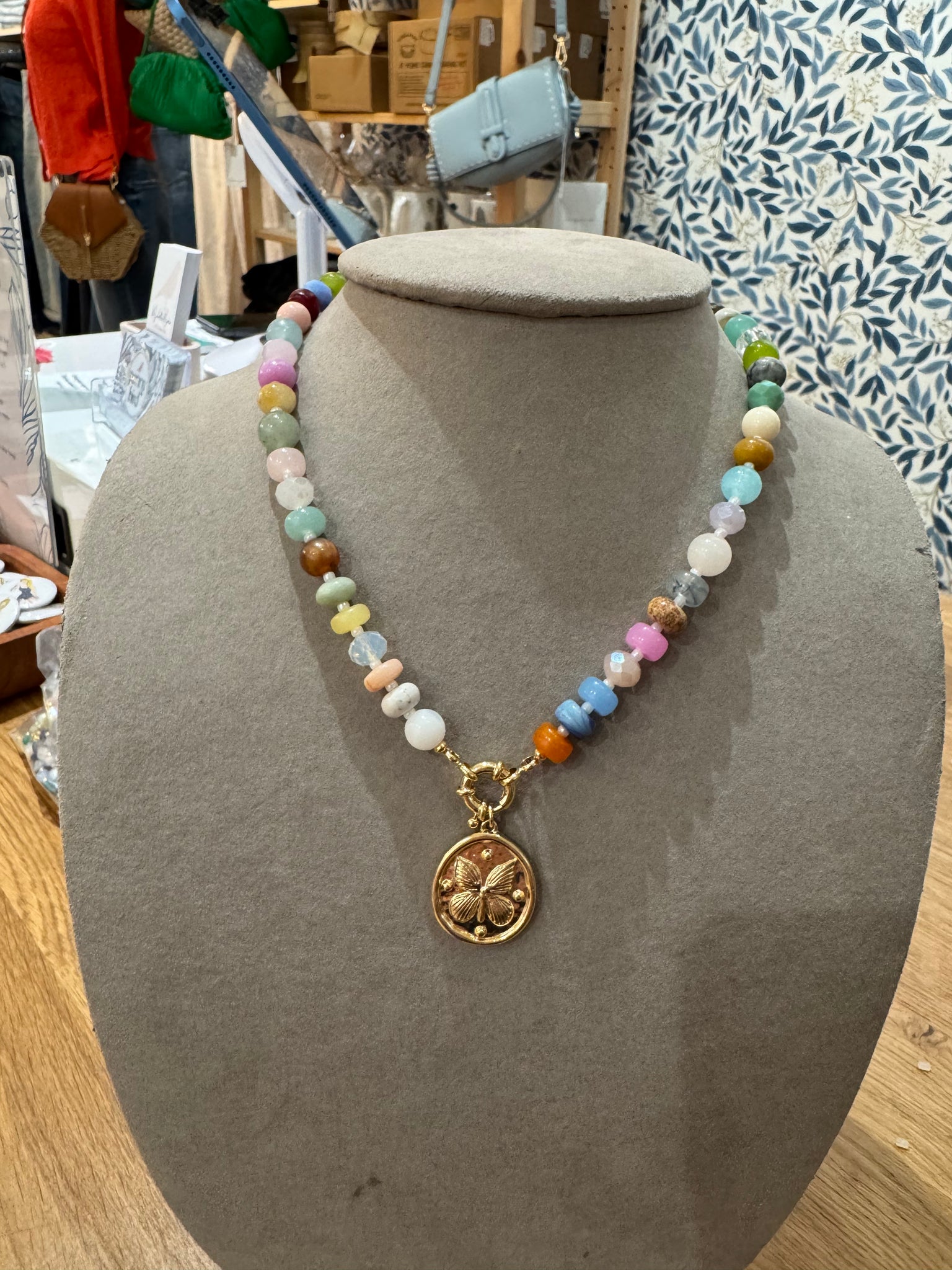 Bead necklace with butterfly charm